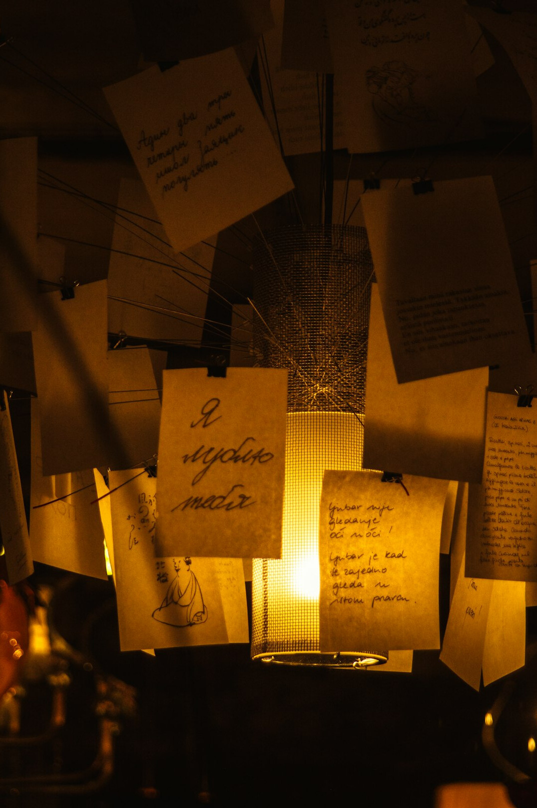 Magnifying glass over notebook and old documents on a wooden desk