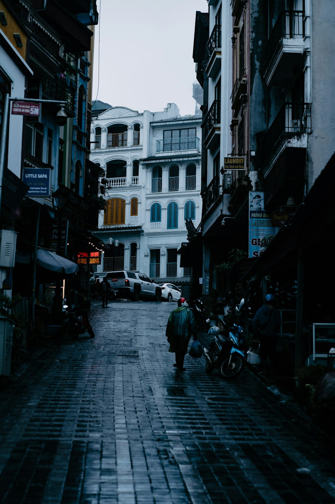 Narrow cobblestone alley in an old city at dusk